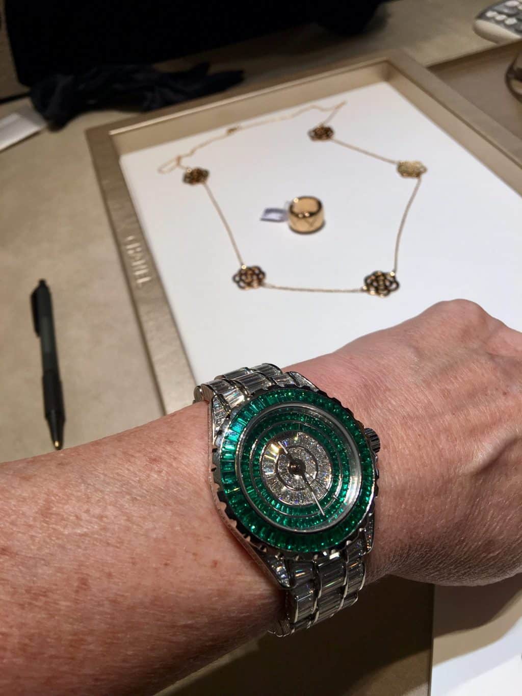 Chanel Paris. Hand is shaking with emerald watch!