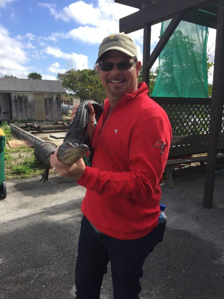 Florida Everglades man holding small alligator