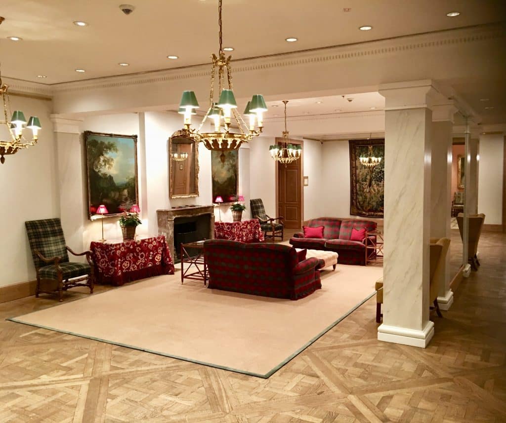 Inside sitting lobby area at Brenners Park-Hotel & Spa; couches, chairs and fireplace