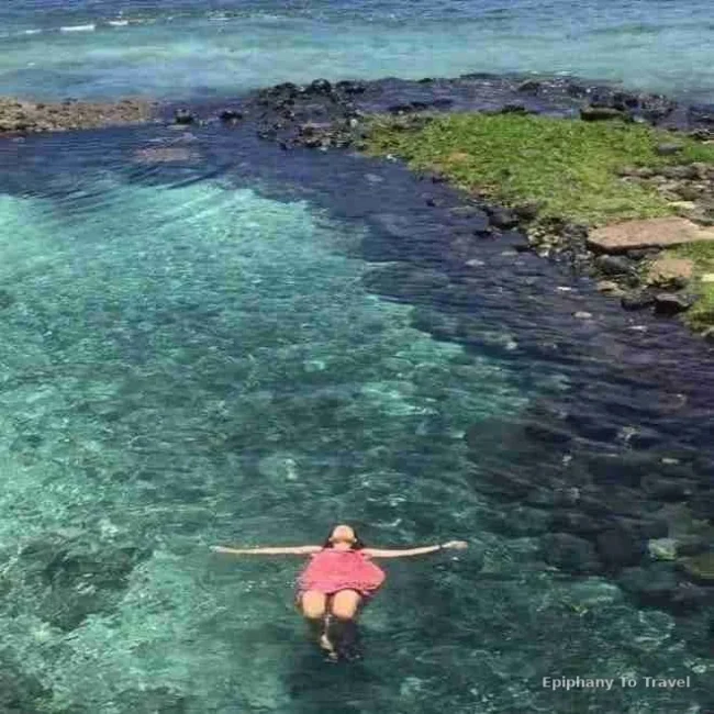 Alex in Samoa laying in the water