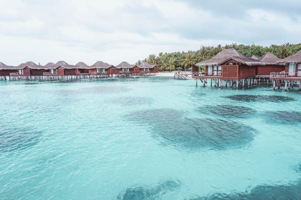 Maldives blue water with huts